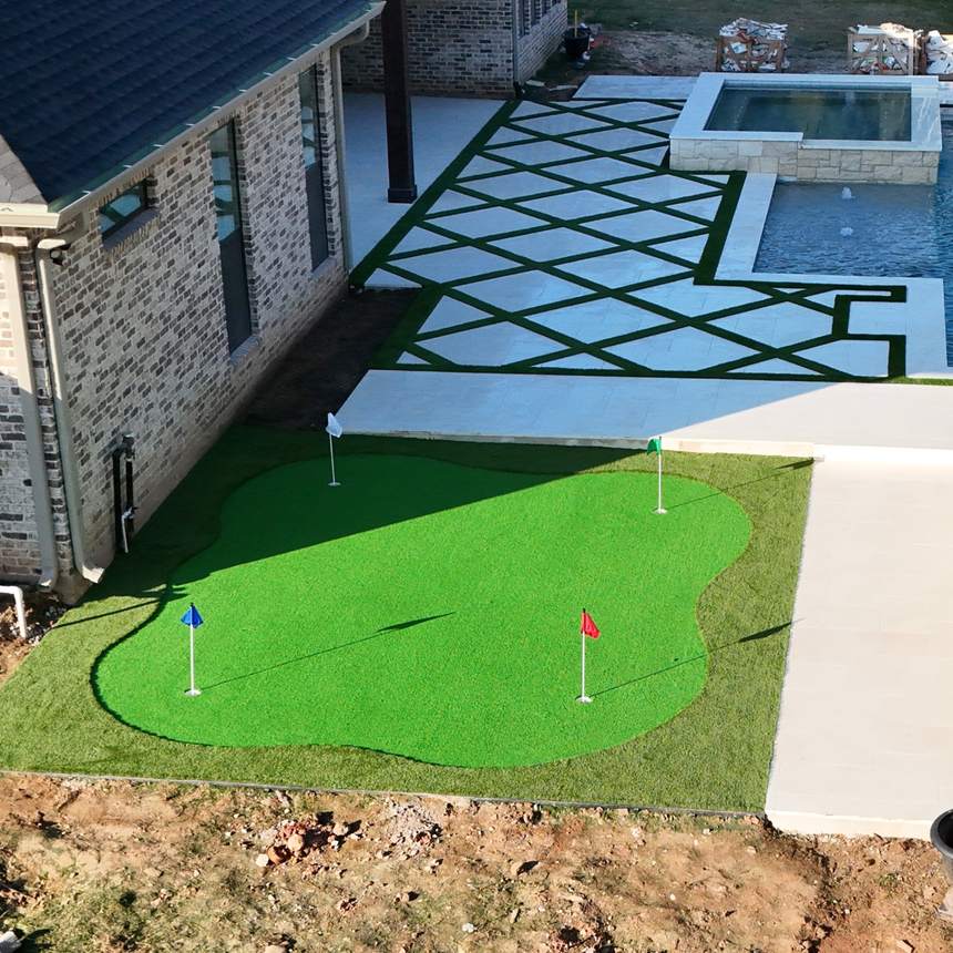 Backyard putting green beside a patio