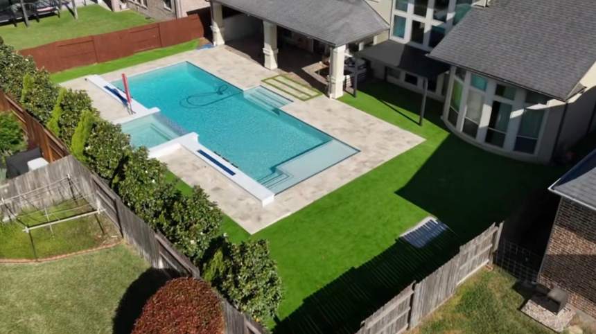 Aerial view of a backyard and pool after premium artificial turf installation