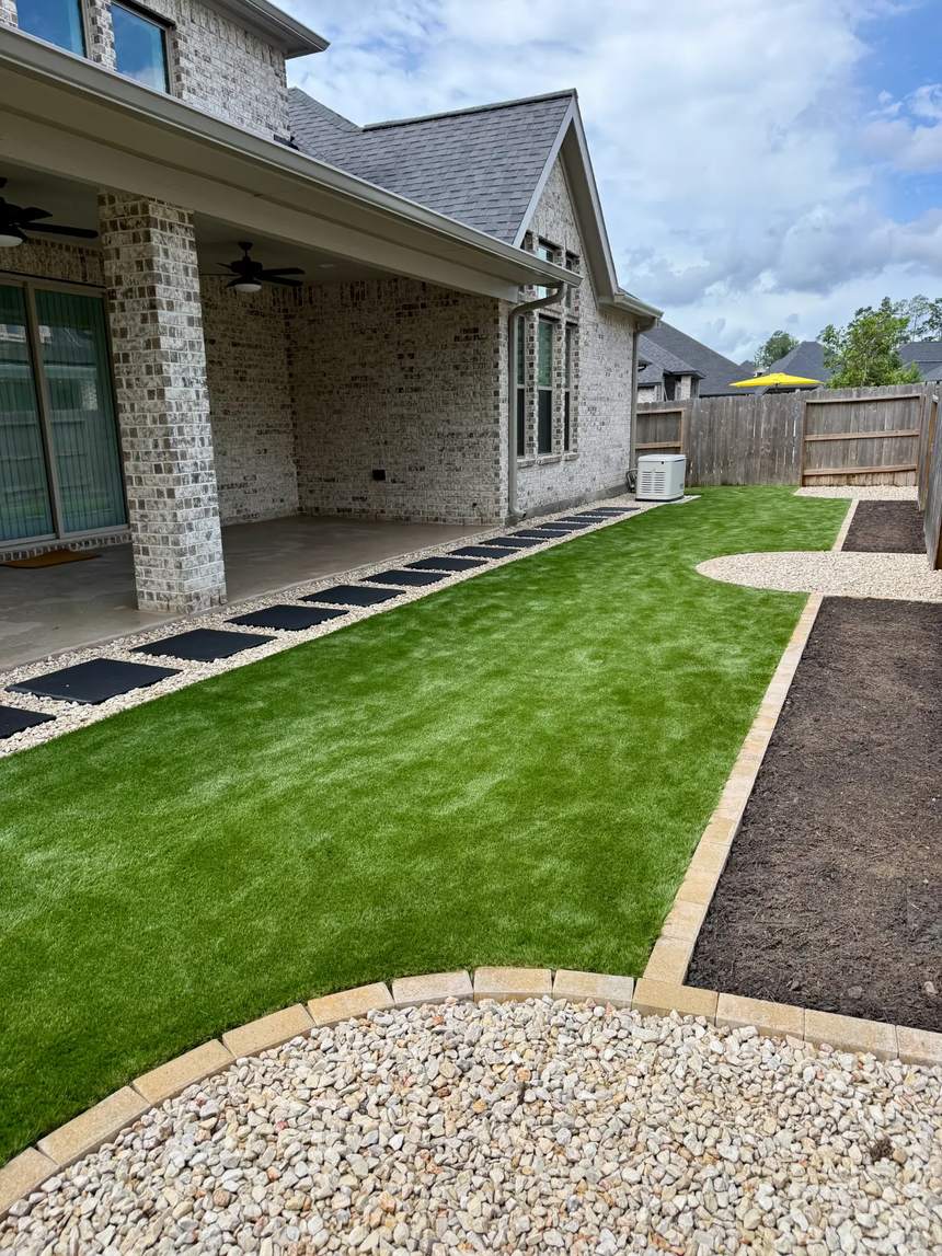 Finished residential artificial turf lawn alongside a Houston home
